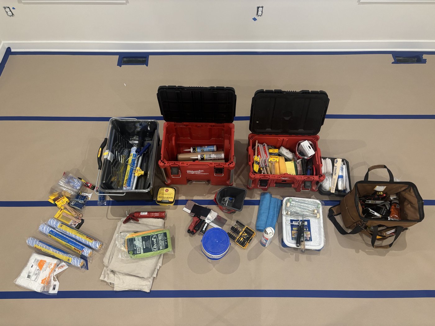 Toolboxes and paint supplies laid out